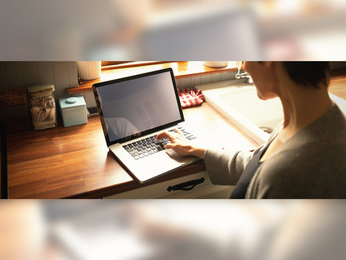 Woman Using Laptop on Kitchen Counter Mockup 220158270